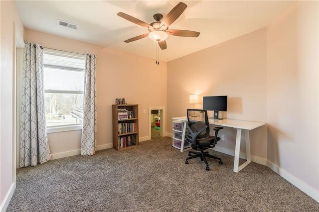 carpeted home office featuring ceiling fan