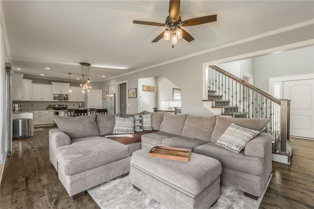 living room featuring sink, crown molding, dark wood-type flooring, and ceiling fan