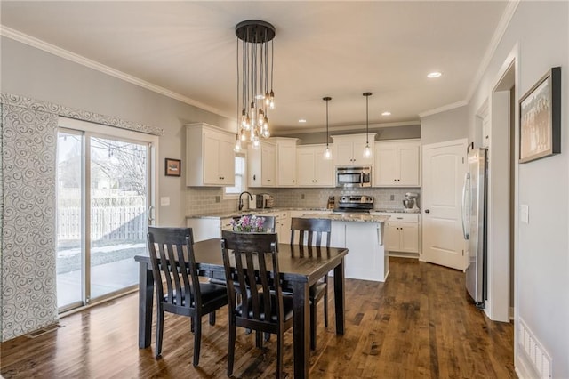 dining room featuring crown molding and dark hardwood / wood-style floors