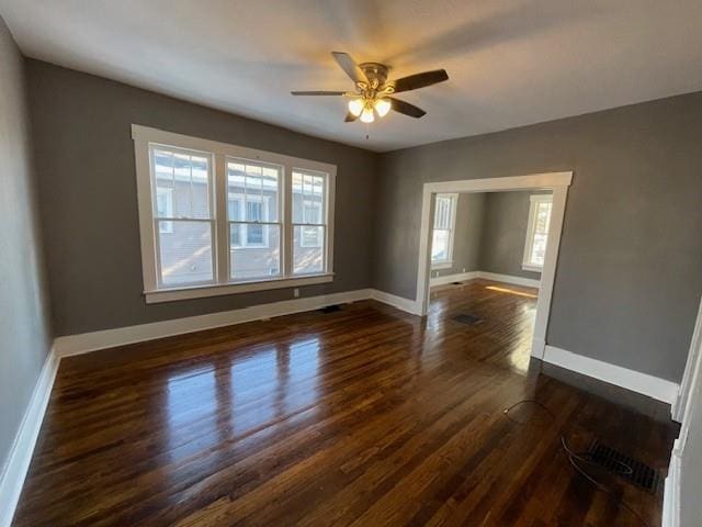 empty room featuring ceiling fan and dark hardwood / wood-style floors