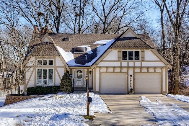 tudor house featuring a garage