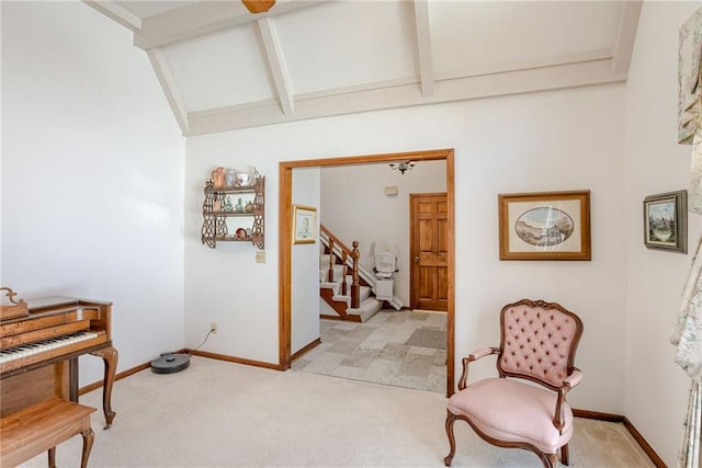 sitting room featuring light colored carpet and vaulted ceiling with beams