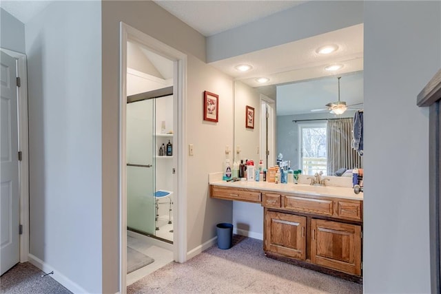 bathroom featuring vanity, a shower with door, and ceiling fan