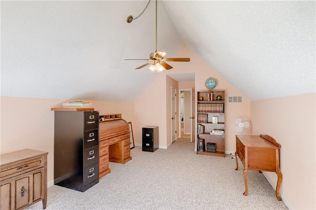 carpeted office space featuring ceiling fan, lofted ceiling, and a textured ceiling