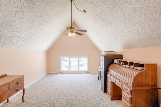 bedroom featuring vaulted ceiling, light carpet, ceiling fan, and a textured ceiling