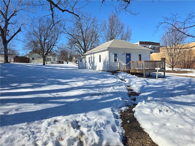 snow covered property featuring a wooden deck