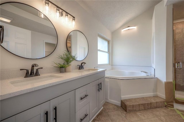 bathroom with tile patterned flooring, vanity, a textured ceiling, vaulted ceiling, and shower with separate bathtub