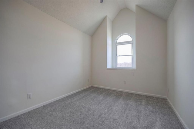 bonus room with vaulted ceiling and carpet floors