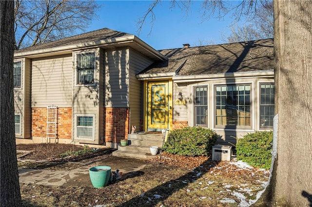 doorway to property with brick siding