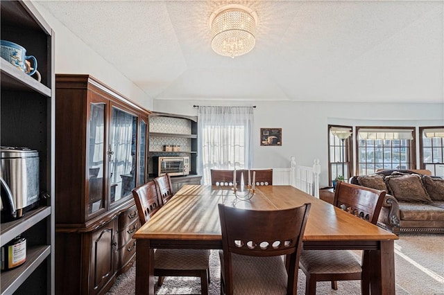 dining room featuring a healthy amount of sunlight, carpet flooring, and lofted ceiling