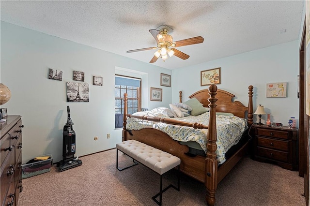 bedroom with a textured ceiling, carpet flooring, and a ceiling fan