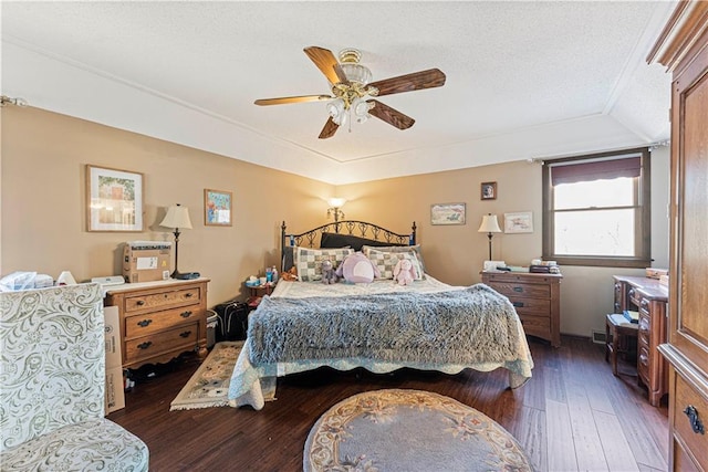 bedroom featuring a textured ceiling, ceiling fan, and wood-type flooring