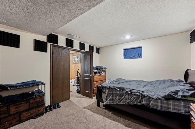 bedroom with carpet and a textured ceiling