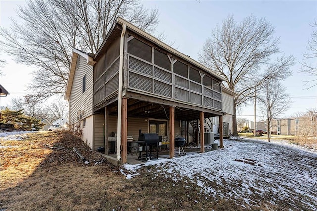 back of property featuring stairs, a patio area, and a sunroom