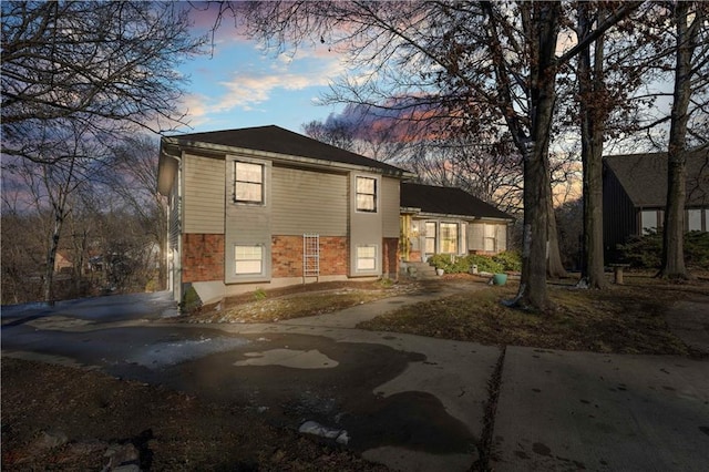 tri-level home with brick siding