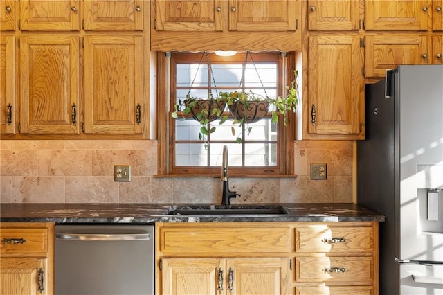 kitchen featuring appliances with stainless steel finishes, sink, and decorative backsplash