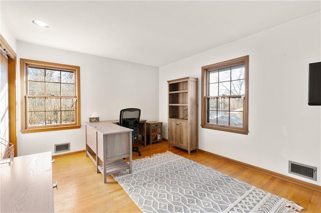 office with light wood-type flooring