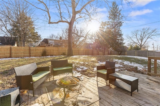 snow covered deck featuring an outdoor living space with a fire pit