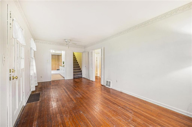 empty room featuring crown molding and hardwood / wood-style floors