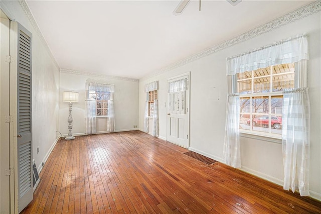 unfurnished bedroom featuring crown molding and hardwood / wood-style floors