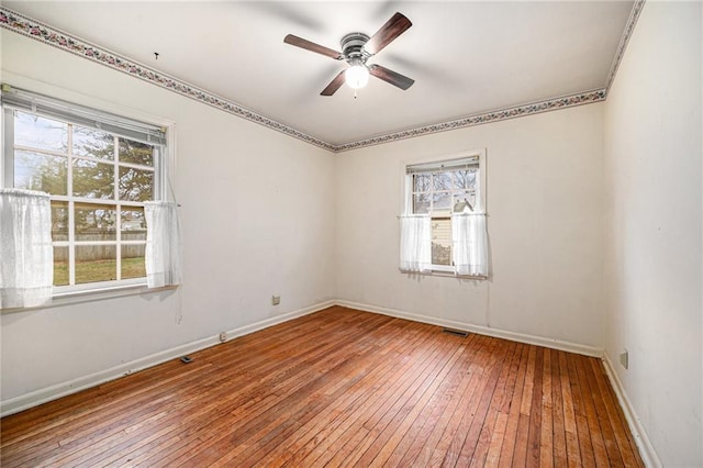 empty room featuring ceiling fan and wood-type flooring