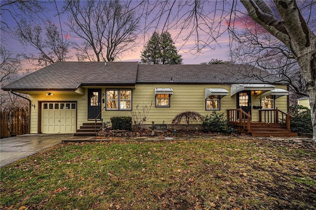 single story home with a garage and a yard