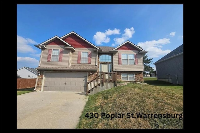 view of front of property featuring a garage and a front yard