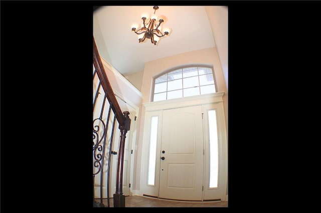 foyer entrance featuring an inviting chandelier