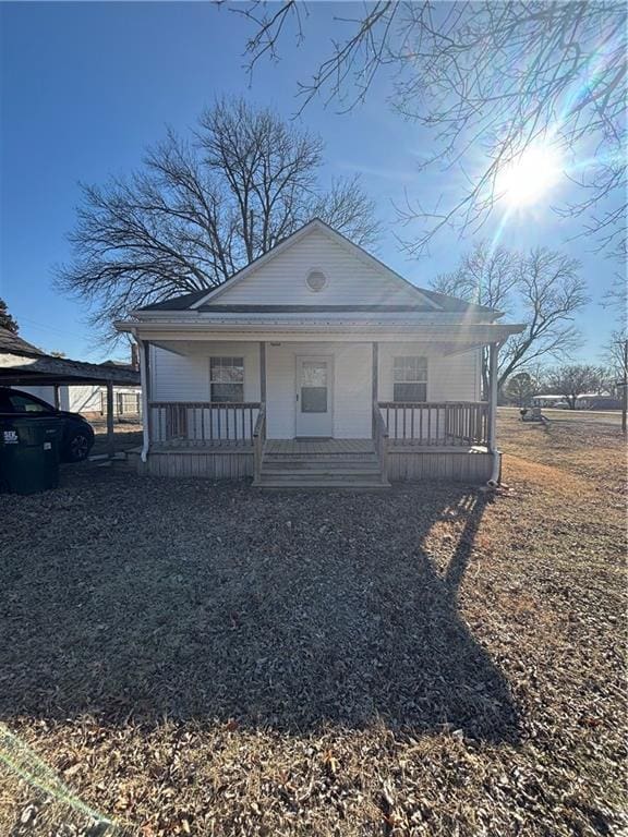 view of front of house featuring a carport and covered porch