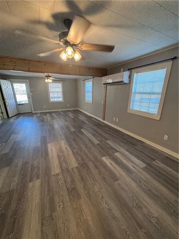 unfurnished room with ceiling fan, a wall mounted air conditioner, and dark hardwood / wood-style flooring