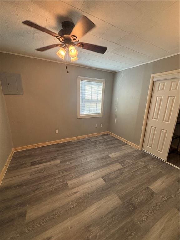 spare room featuring ceiling fan, dark hardwood / wood-style flooring, and electric panel