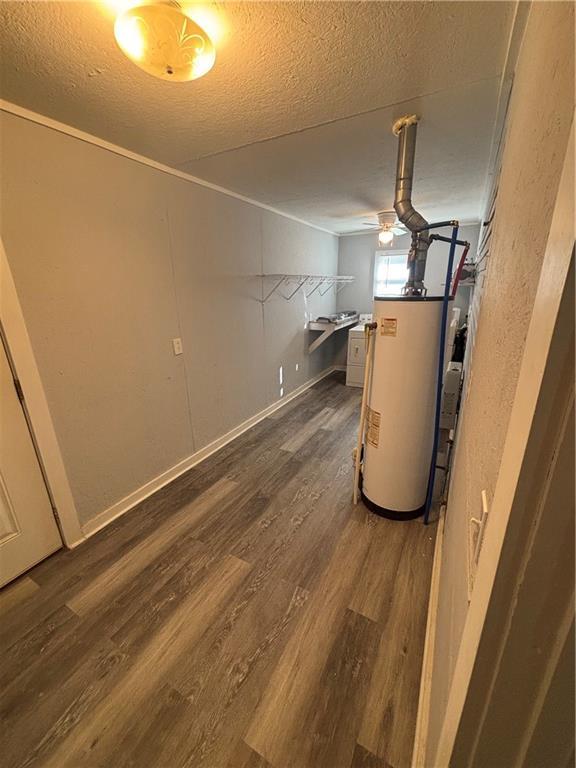 utility room featuring water heater