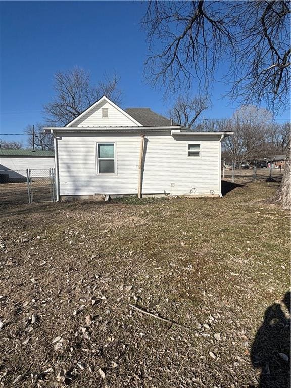 view of side of home featuring a lawn