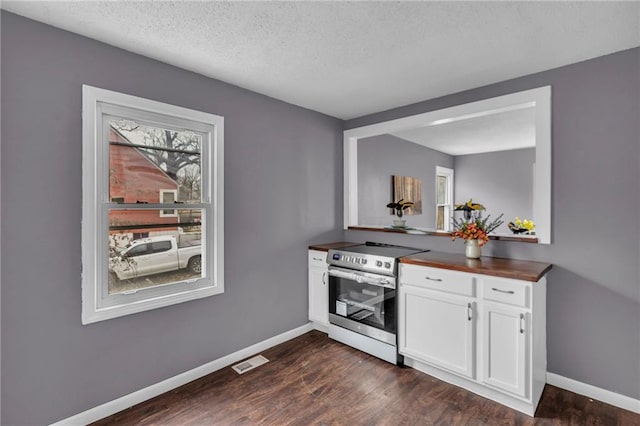 kitchen with white cabinetry, electric range, dark wood-type flooring, and a textured ceiling