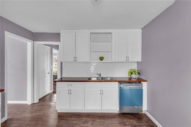 kitchen with sink, dark wood-type flooring, dishwasher, white cabinetry, and wood counters