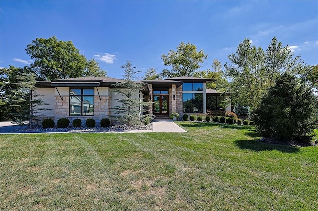 view of front of house featuring french doors and a front lawn