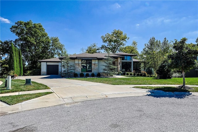 view of front of home with a garage and a front lawn