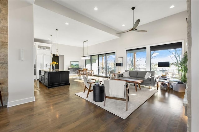 living room featuring dark wood-type flooring and ceiling fan