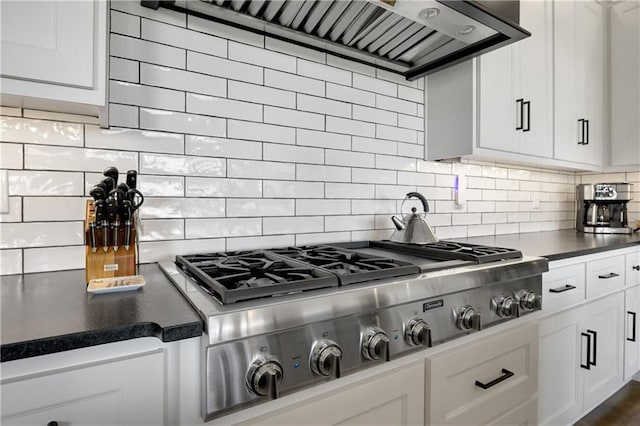 kitchen featuring white cabinetry, tasteful backsplash, stainless steel gas cooktop, and wall chimney exhaust hood