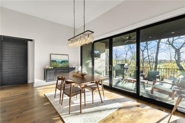 dining room with hardwood / wood-style flooring and a wealth of natural light