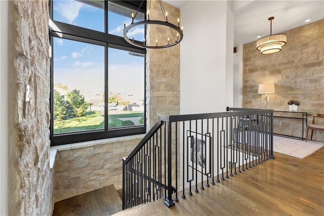 stairs featuring a chandelier and hardwood / wood-style floors