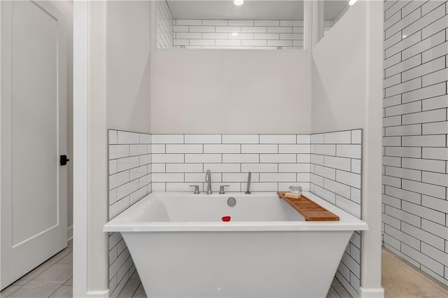 bathroom featuring tile walls and a tub to relax in