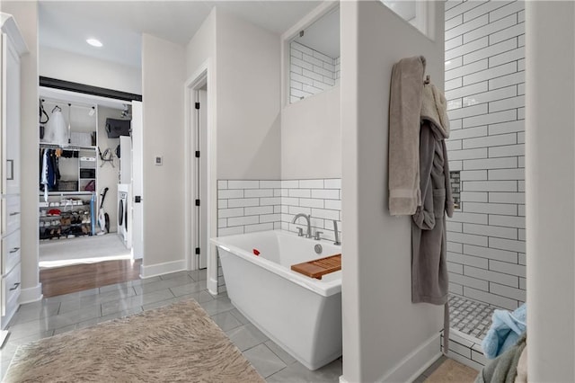 bathroom with tile patterned floors and shower with separate bathtub