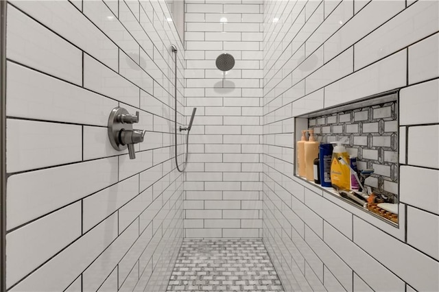 bathroom with a tile shower