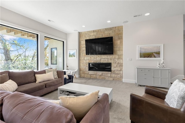 carpeted living room with a large fireplace