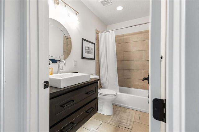 full bathroom featuring shower / tub combo with curtain, vanity, tile patterned flooring, and toilet