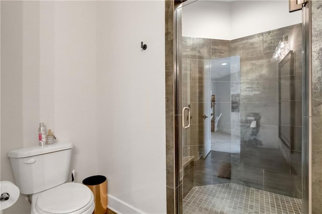 bathroom featuring toilet and walk in shower