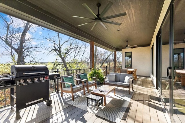 wooden deck featuring ceiling fan, an outdoor living space, and area for grilling