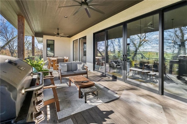 wooden deck with a grill, an outdoor living space, and ceiling fan