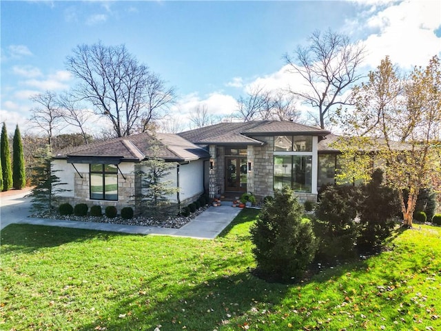 prairie-style home featuring a sunroom and a front lawn